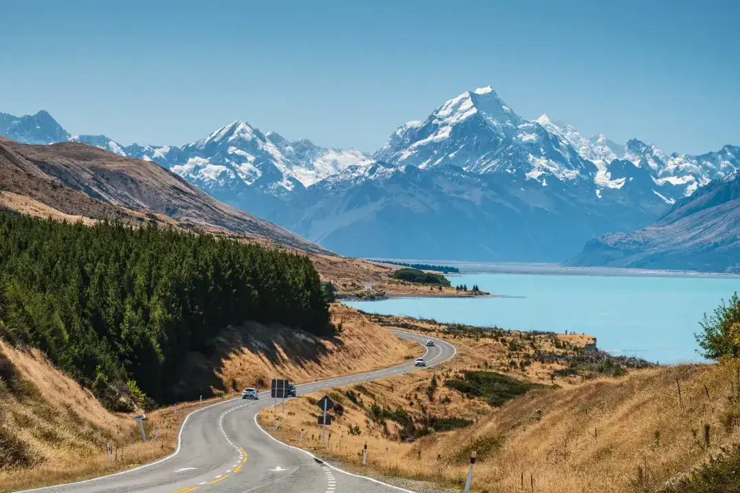 Scenic winding road with mountains and lake