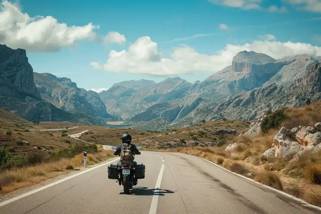 Motorcyclist riding through scenic mountains
