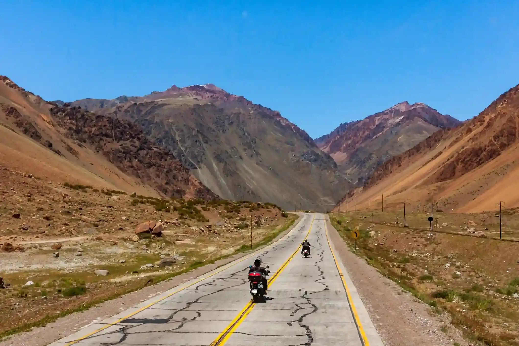 Two adventure motorcycles on Ruta Nacional 7, crossing the Argentine Andes toward the Chilean border.